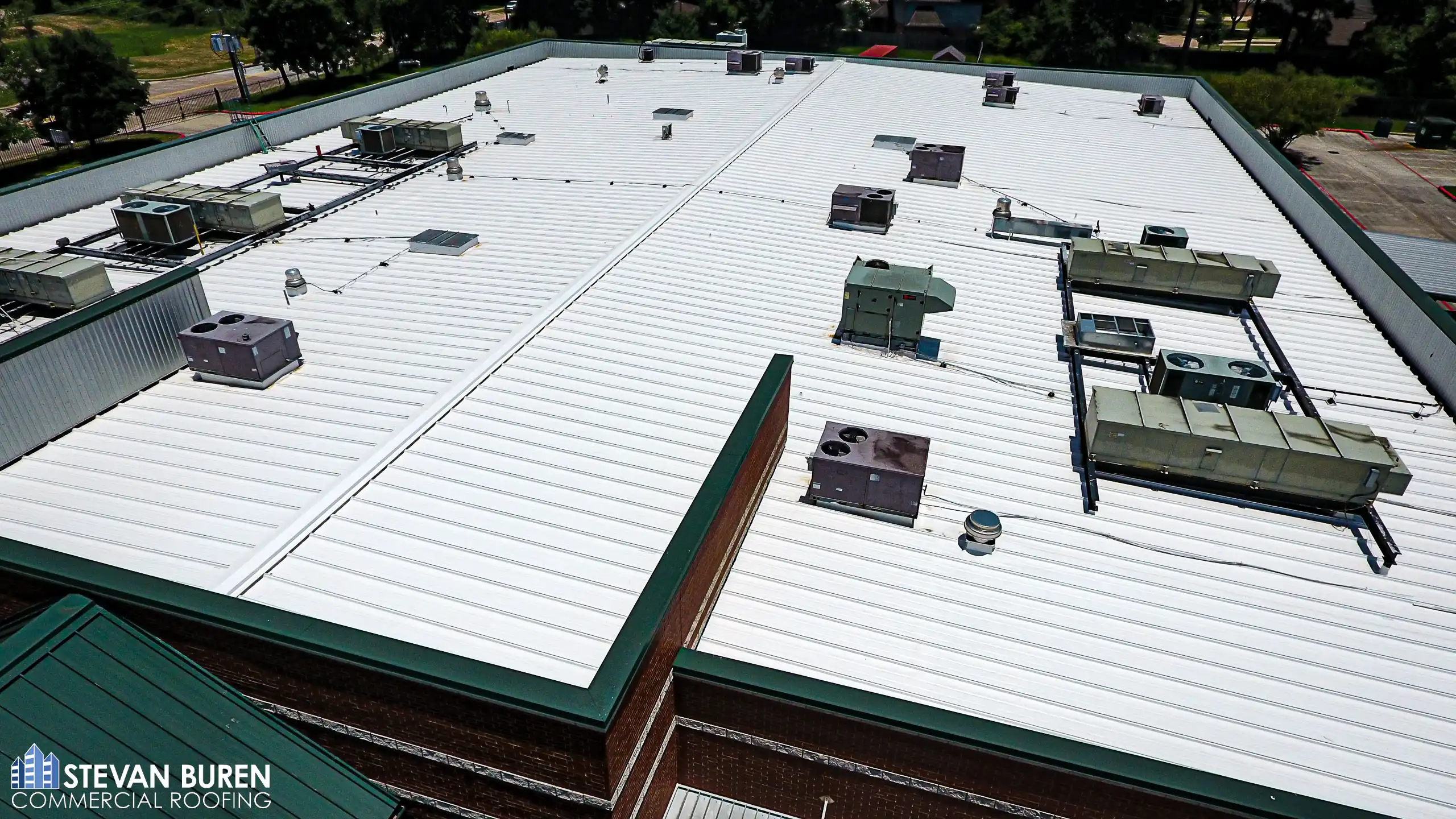 Commercial metal roof with white roof coating system
