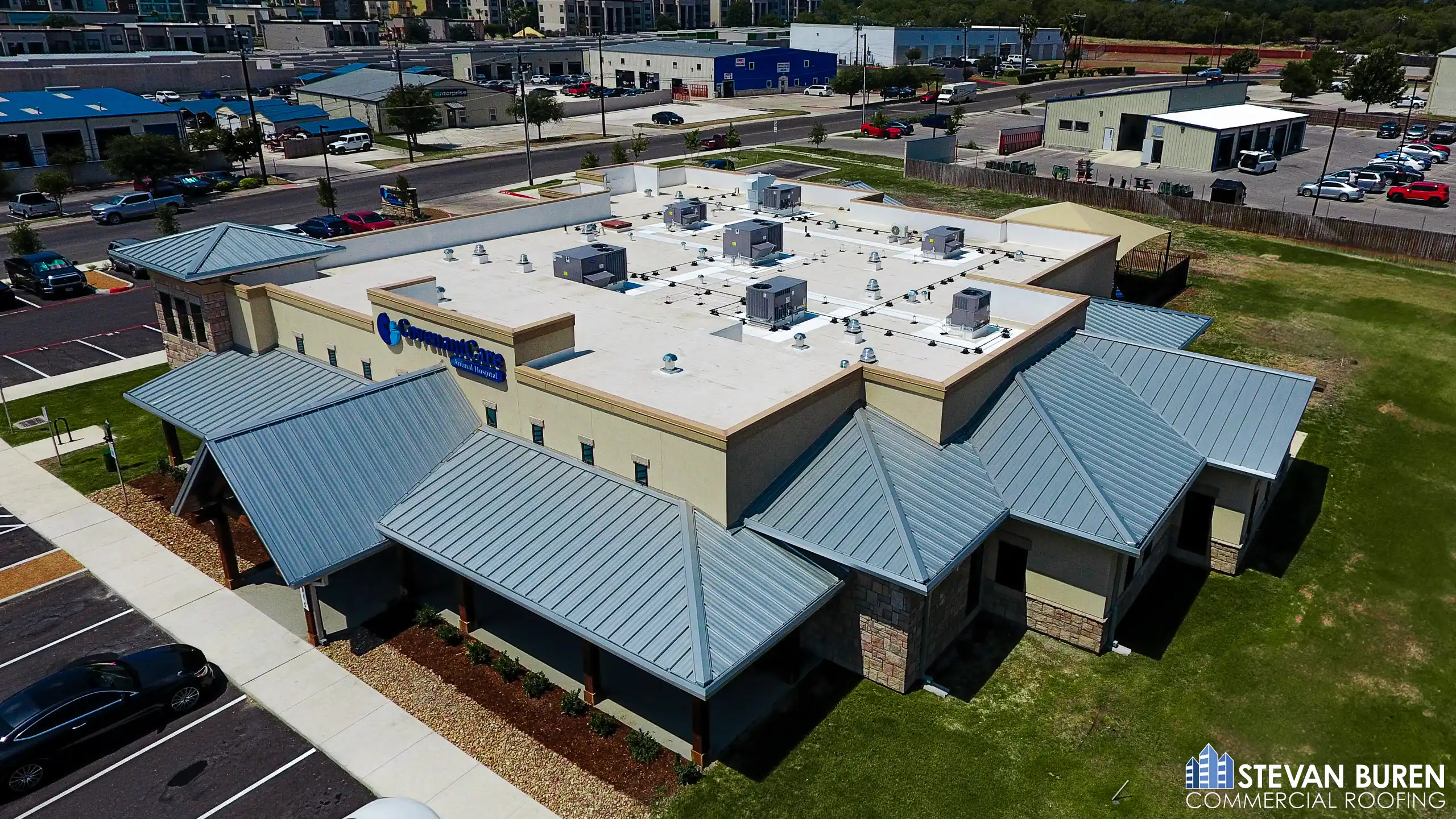Commercial building with TPO flat roof and metal roof sections